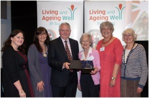 Councillor Mel Few presents Surrey Libraries with the Help at Home Award